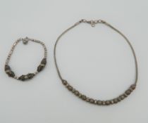 A silver necklace and bracelet set. The former 41 cm long. 33.6 grammes.