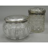 Two silver topped dressing jars. The largest 10.5 cm high.