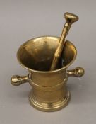 An 18th century bronze pestle and mortar. The latter 12.5 cm high.