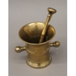 An 18th century bronze pestle and mortar. The latter 12.5 cm high.