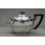 A silver teapot. 28 cm long. 18.9 troy ounces total weight.