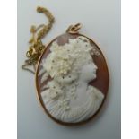 A 19th century carved cameo shell pendant, with 9 ct gold surround and 925 silver chain.