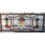 An Art Nouveau leaded stained glass panel. 102 cm wide.