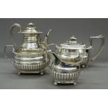 A matched Georgian silver four piece tea set. The teapot 28.5 cm long. 61.