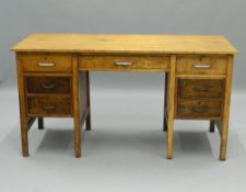 An early/mid-20th century kneehole desk. 146 cm wide. The property of Germaine Greer.