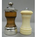 A sterling silver mounted peppermill and an early 20th century ivory peppermill. The former 10.