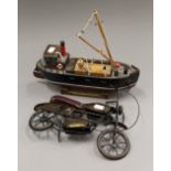 A model of a motorbike and a boat. The boat 32 cm long.