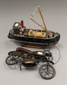 A model of a motorbike and a boat. The boat 32 cm long.