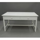 A modern white painted two-drawer table. 149 cm wide. The property of Germaine Greer.