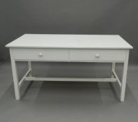 A modern white painted two-drawer table. 149 cm wide. The property of Germaine Greer.