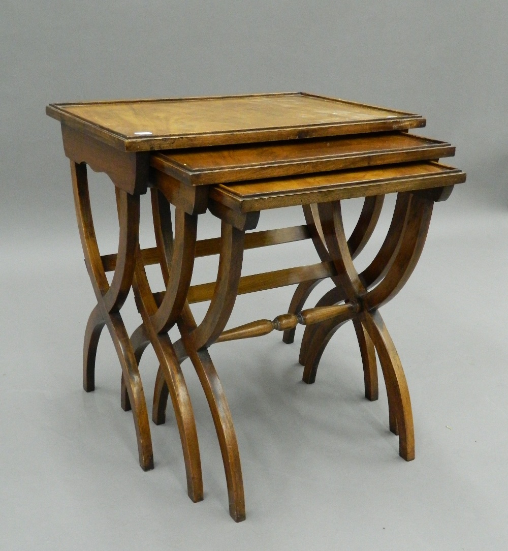 A nest of three mahogany tables. 56 cm wide.