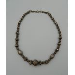 A silver beaded necklace. 42 cm long.