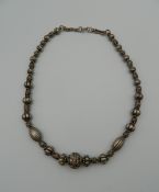 A silver beaded necklace. 42 cm long.