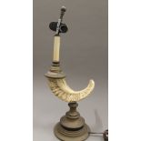 A decorative table lamp formed as a rams horn. 54 cm high overall.