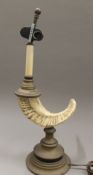 A decorative table lamp formed as a rams horn. 54 cm high overall.