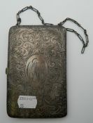 An engraved silver purse on chain. 8 cm wide. 151.3 grammes total weight.