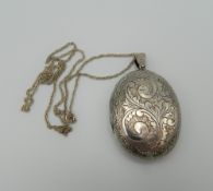 A silver double photo locket on chain. 5 cm high. 26 grammes total weight.