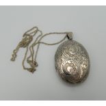 A silver double photo locket on chain. 5 cm high. 26 grammes total weight.