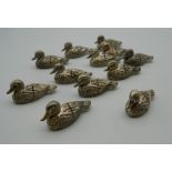 A set of twelve place card holders formed as ducks. Each 4.5 cm long.