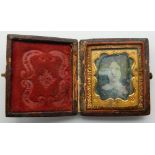 A small leather cased daguerreotype portrait of a girl. 5 cm high.