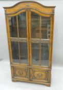 An early 20th century glazed oak cabinet. 103 cm wide x 192 cm high.