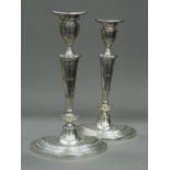 A pair of oval based silver candlesticks, hallmarked for Birmingham 1919. 29.5 cm high.