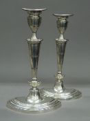 A pair of oval based silver candlesticks, hallmarked for Birmingham 1919. 29.5 cm high.