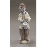 Three Lladro clown groups. The largest 25 cm high.