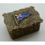 A Victorian brass box, set with an enamel flag. 7 cm wide.