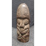 A late 19th century Maori carved wooden totem. 69 cm high.