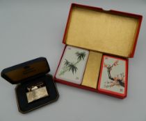 A cased set of Glen Line playing cards and a boxed Ronson lighter.