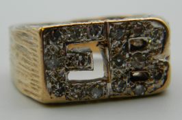 A 9 ct gold diamond ring formed as the initials E.B. Ring Size O/P. 11.6 grammes total weight.