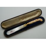 A Victorian cased carved coral handled silver gilt mounted and mother-of-pearl letter opener. 23.