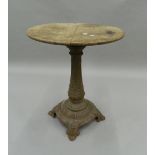 A Victorian oak topped cast iron garden table. 75 cm high.