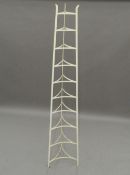A white painted tall saucepan rack. 197.5 cm high. The property of Germaine Greer.
