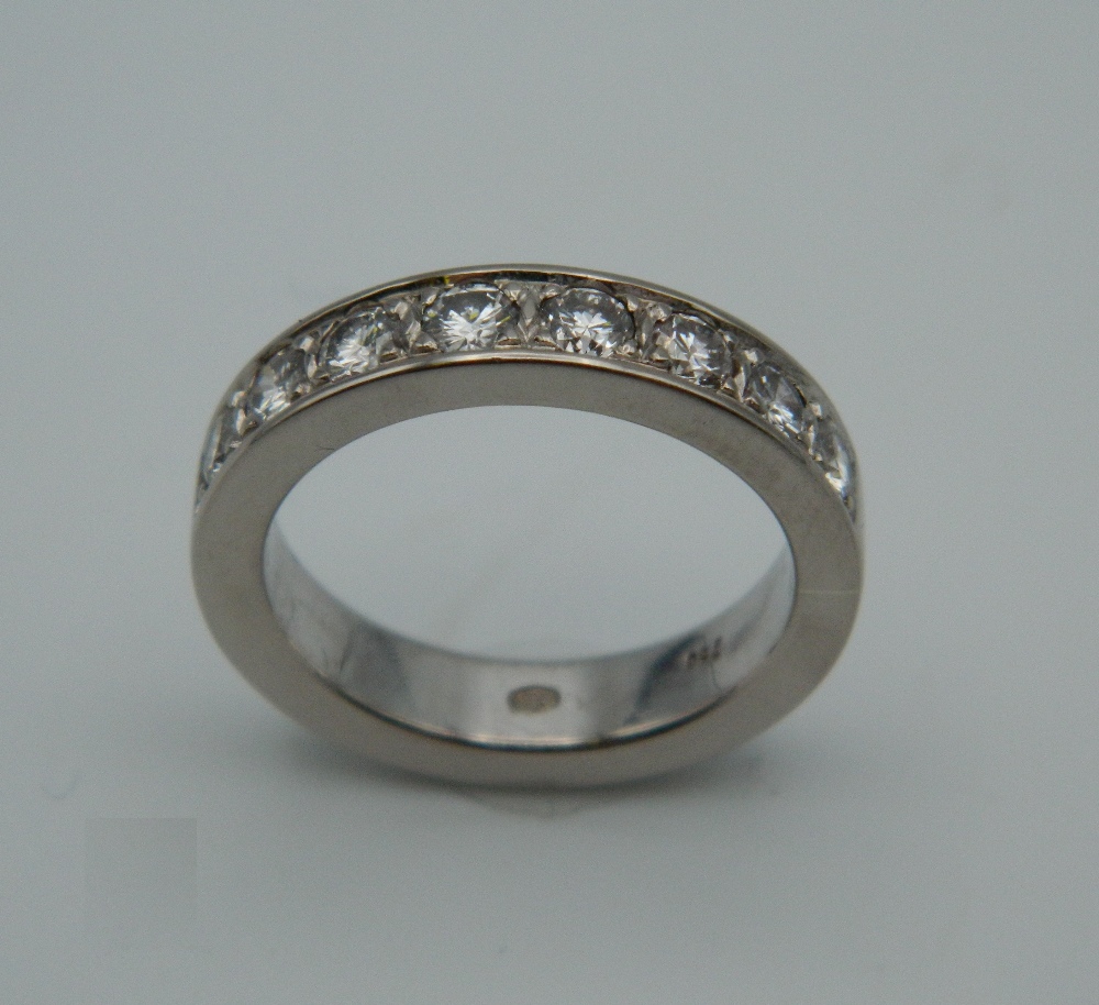 A good quality 18 ct white gold eight stone diamond band. Ring Size P. 10.