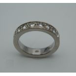 A good quality 18 ct white gold eight stone diamond band. Ring Size P. 10.