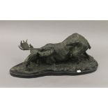 A patinated bronze model of a moose. 62 cm long.