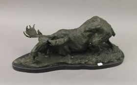 A patinated bronze model of a moose. 62 cm long.