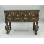 An early 20th century carved oak two drawer side table. 106 cm wide.