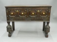 An early 20th century carved oak two drawer side table. 106 cm wide.