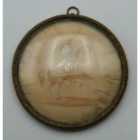 A 19th century framed miniature depicting a soldier on horseback. 7 cm diameter.