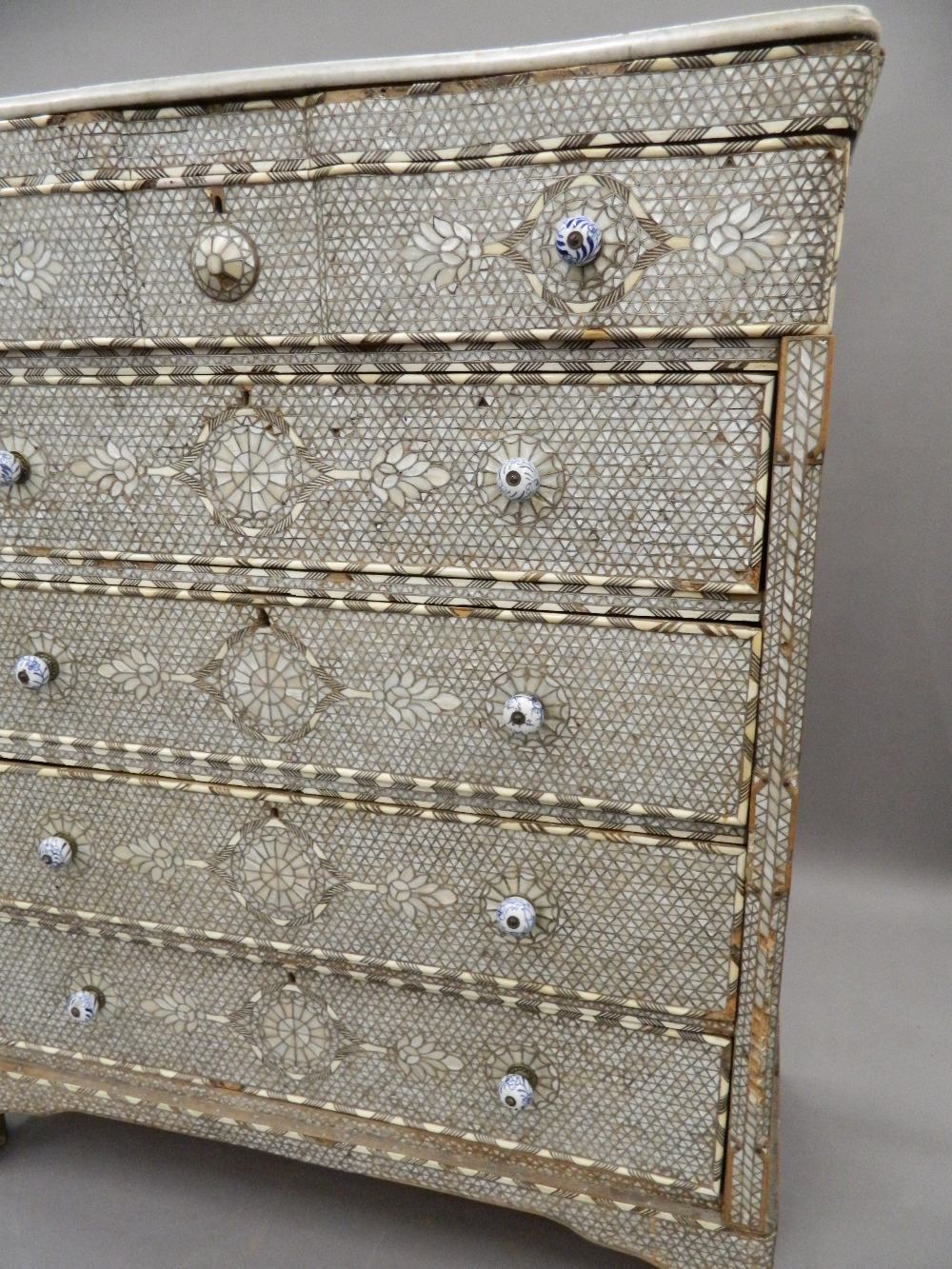 A Syrian mother-of-pearl inlaid chest of drawers with associated marble top. - Image 16 of 25