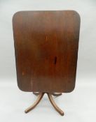 A 19th century rectangular mahogany tilt-top table. 106 cm long.