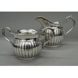 A 925 silver sugar bowl and a matching cream jug. The jug 9 cm high. 9.6 troy ounces.