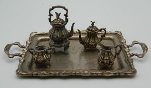 A miniature sterling silver tea set and tray. The tray is 16 cm wide. 179 grammes.
