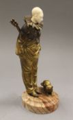 An early 20th century ivory mounted gilt bronze model of a clown and a cat. 22.5 cm high.