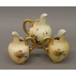 Three Royal Worcester blush ivory florally decorated jugs. The largest 15 cm high.