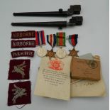 A collection of British Airborne WWII medals and box, with papers and uniform patches, etc.