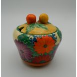 A Bizarre by Clarice Cliff lidded preserve pot in the Gayday pattern. 8.5 cm high.